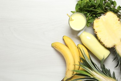 Photo of Superfood. Tasty smoothie and ingredients on light wooden table, flat lay. Space for text