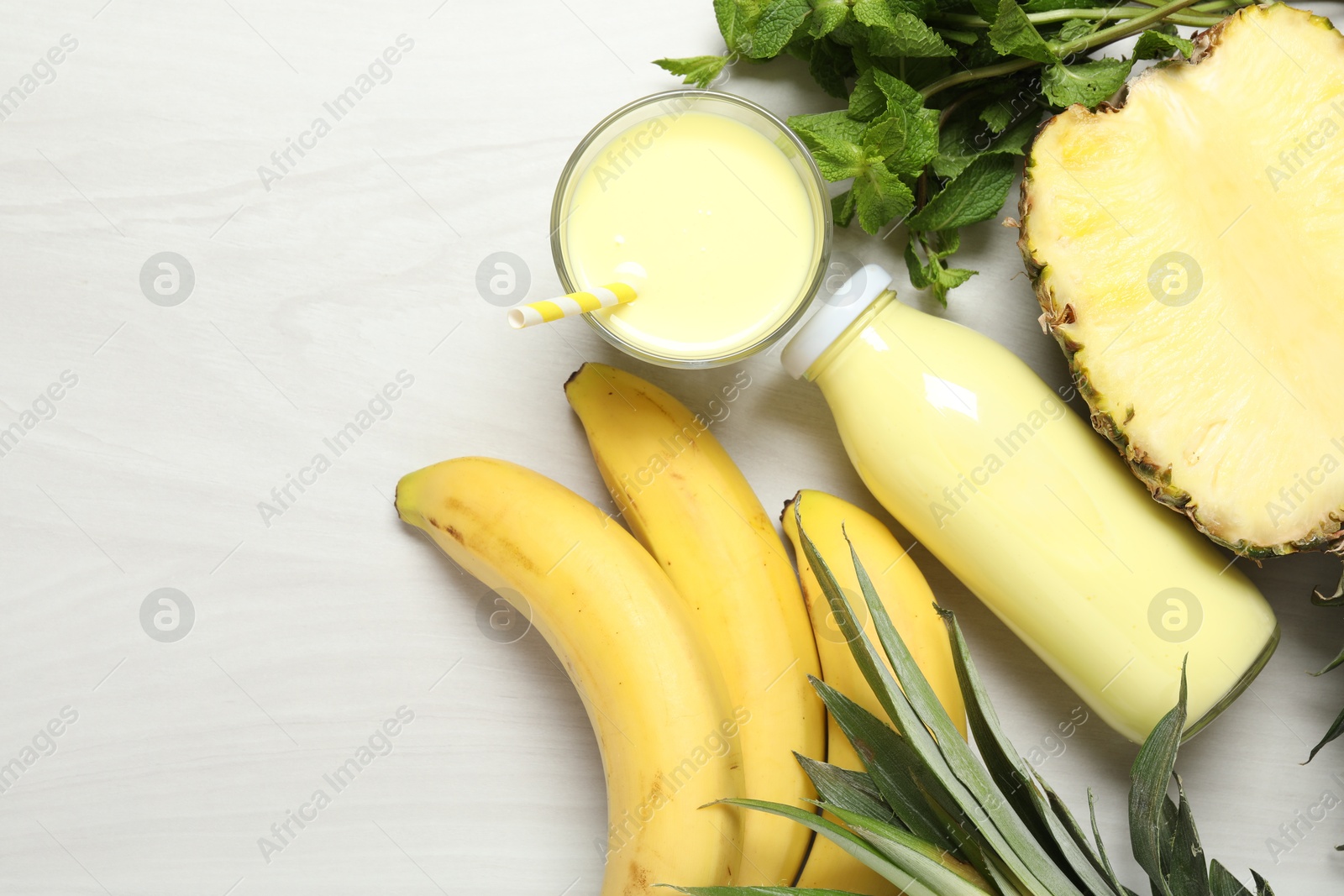 Superfood. Tasty smoothie and ingredients on light wooden table, flat lay. Space for text Photo of Superfood. Tasty smoothie and ingredients on light wooden table, flat lay. Space for text