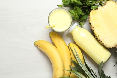 Photo of Superfood. Tasty smoothie and ingredients on light wooden table, flat lay. Space for text