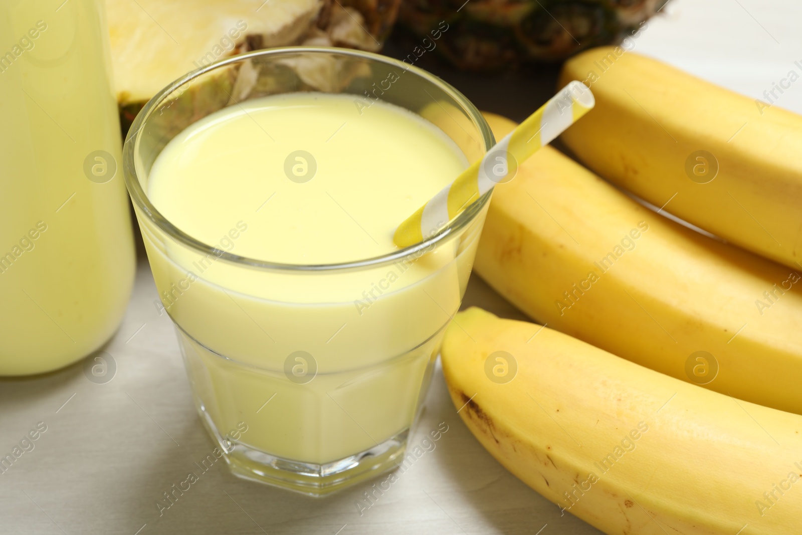 Superfood. Tasty smoothie in glass and ingredients on light wooden table, closeup Photo of Superfood. Tasty smoothie in glass and ingredients on light wooden table, closeup