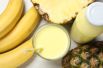 Photo of Superfood. Healthy drink in glass and ingredients on light wooden table, flat lay