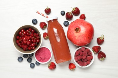 Photo of Superfood. Tasty smoothie in bottle and ingredients on light wooden table, flat lay