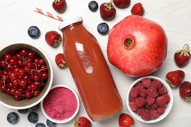 Photo of Superfood. Tasty smoothie in bottle and ingredients on light wooden table, flat lay