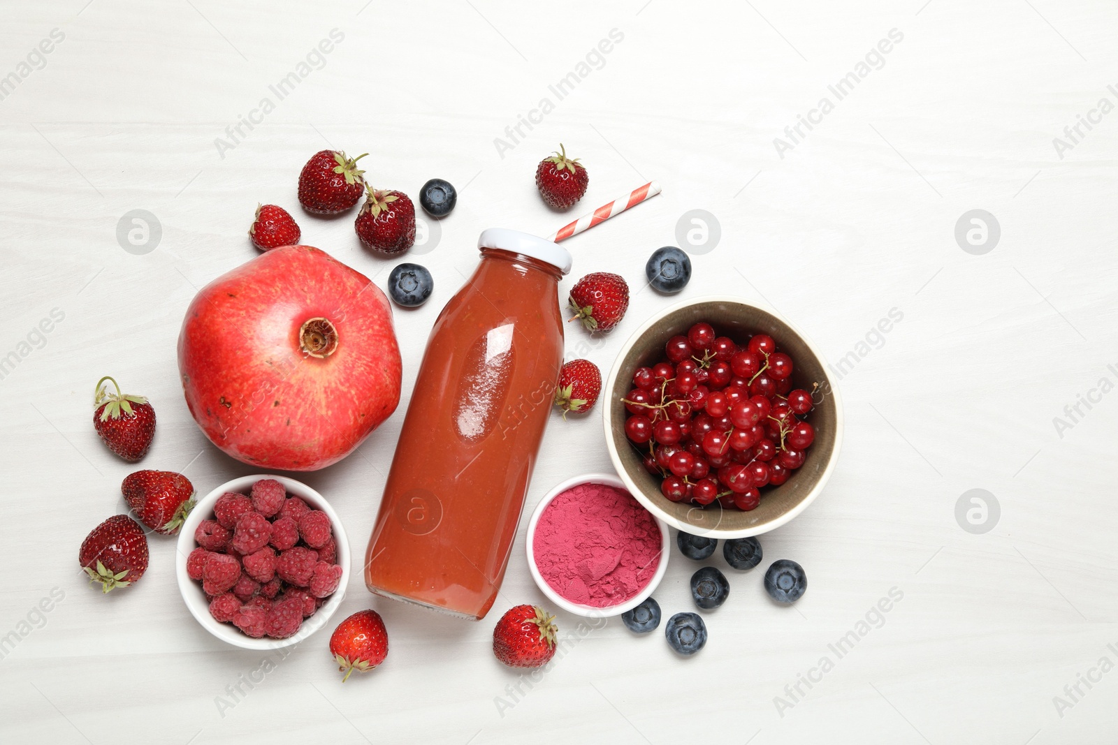 Superfood. Tasty smoothie in bottle and ingredients on light wooden table, flat lay Photo of Superfood. Tasty smoothie in bottle and ingredients on light wooden table, flat lay