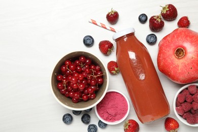 Photo of Superfood. Tasty smoothie in bottle and ingredients on light wooden table, flat lay