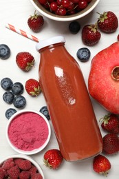 Photo of Superfood. Tasty smoothie in bottle and ingredients on light wooden table, flat lay