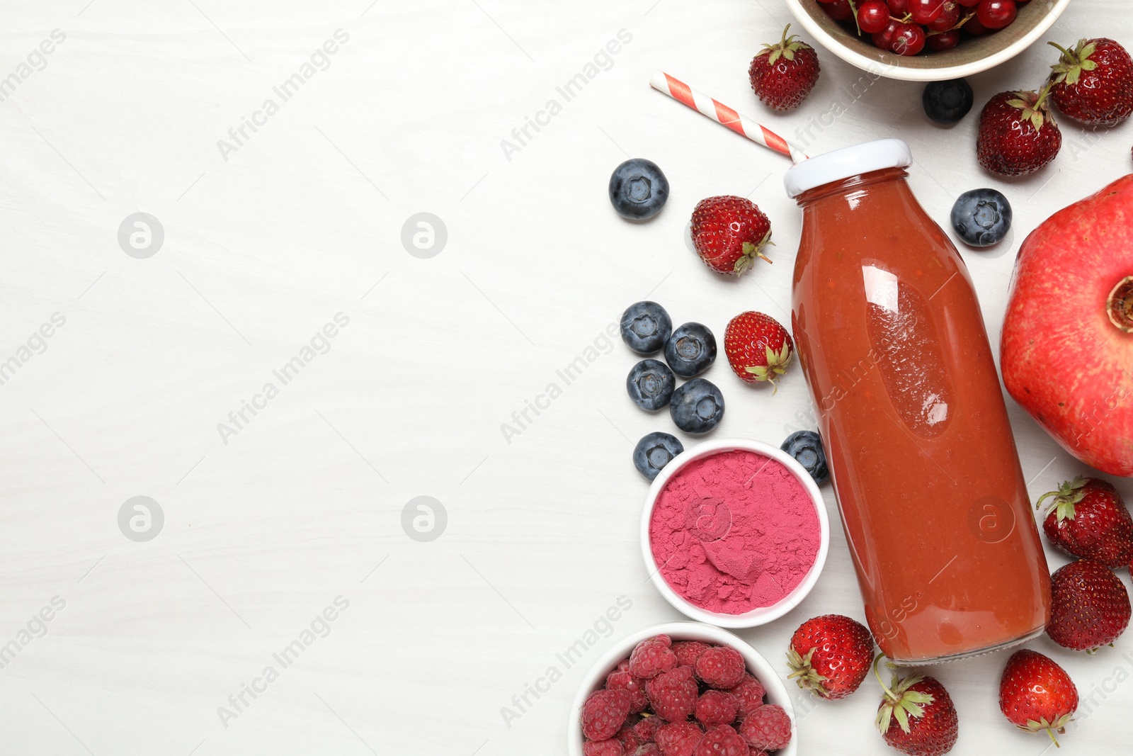 Superfood. Tasty smoothie in bottle and ingredients on light wooden table, flat lay. Space for text Photo of Superfood. Tasty smoothie in bottle and ingredients on light wooden table, flat lay. Space for text