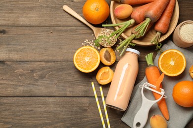 Photo of Superfood. Tasty smoothie in bottle and ingredients on wooden table, flat lay. Space for text