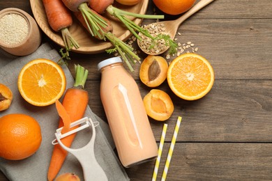 Photo of Superfood. Tasty smoothie in bottle and ingredients on wooden table, flat lay