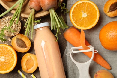 Photo of Superfood. Tasty smoothie in bottle and ingredients on wooden table, flat lay