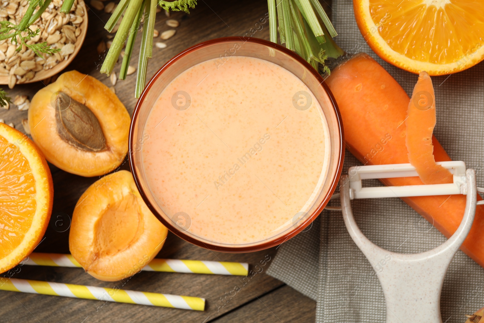 Superfood. Tasty smoothie in glass and ingredients on wooden table, flat lay Photo of Superfood. Tasty smoothie in glass and ingredients on wooden table, flat lay