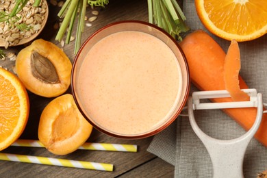 Photo of Superfood. Tasty smoothie in glass and ingredients on wooden table, flat lay