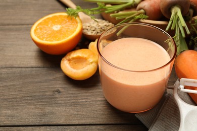 Photo of Superfood. Tasty smoothie in glass and ingredients on wooden table, closeup
