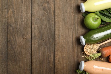 Photo of Superfood. Tasty smoothies in bottles and ingredients on wooden table, flat lay. Space for text