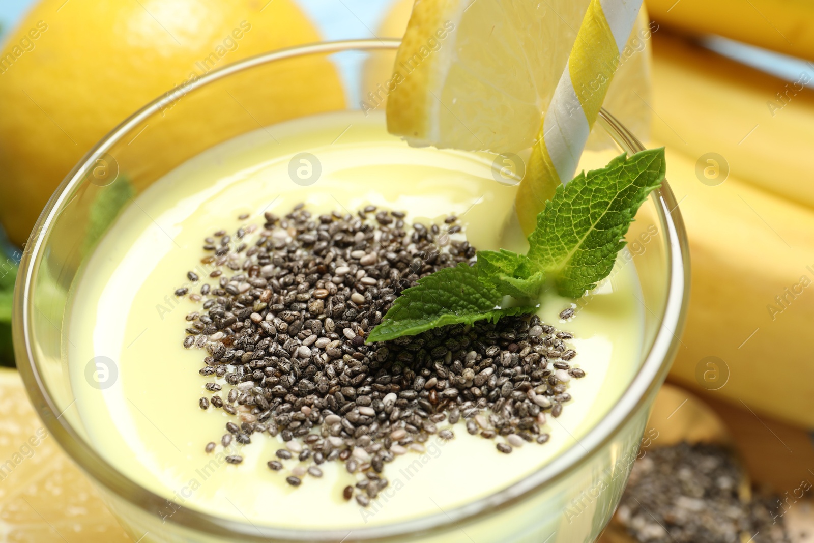 Superfood. Tasty smoothie with chia seeds in glass and ingredients on table, closeup Photo of Superfood. Tasty smoothie with chia seeds in glass and ingredients on table, closeup