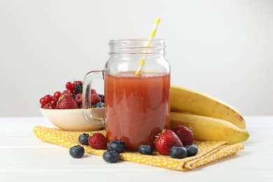 Photo of Superfood. Healthy drink in mason jar and ingredients on white wooden table against light grey background, closeup