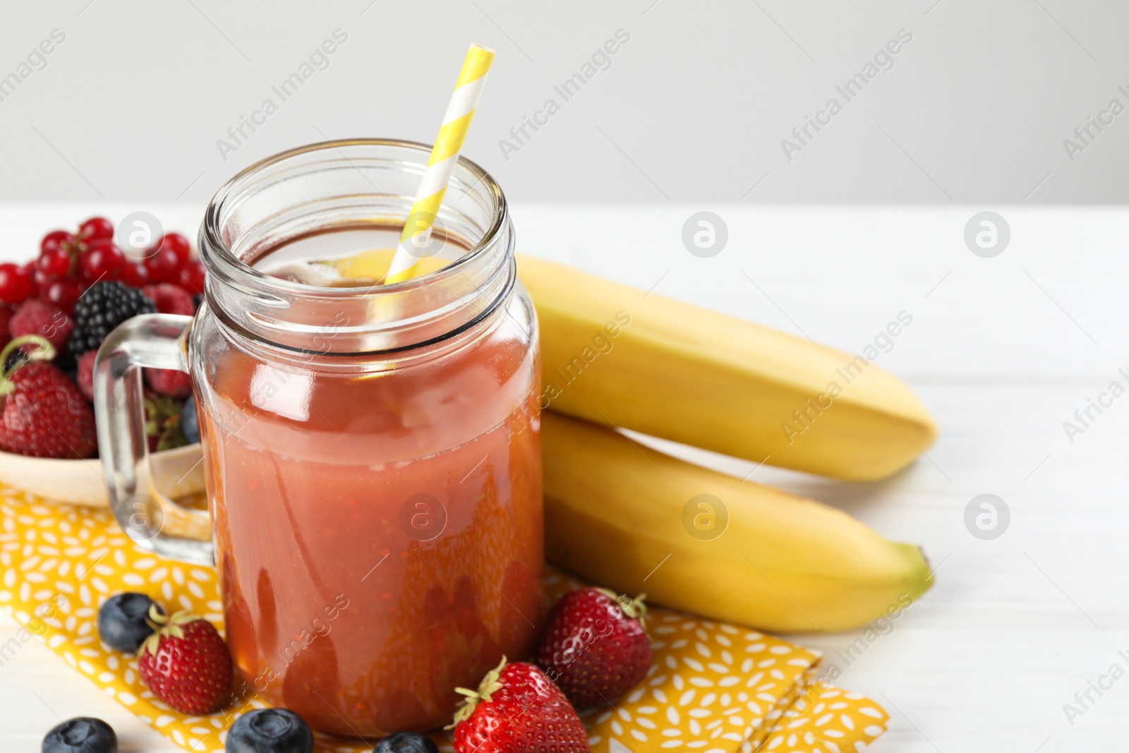 Superfood. Healthy drink in mason jar and ingredients on white wooden table against light grey background, closeup Photo of Superfood. Healthy drink in mason jar and ingredients on white wooden table against light grey background, closeup