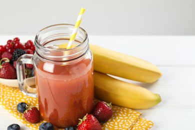 Photo of Superfood. Healthy drink in mason jar and ingredients on white wooden table against light grey background, closeup