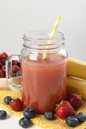 Photo of Superfood. Healthy drink in mason jar and ingredients on white wooden table against light grey background, closeup