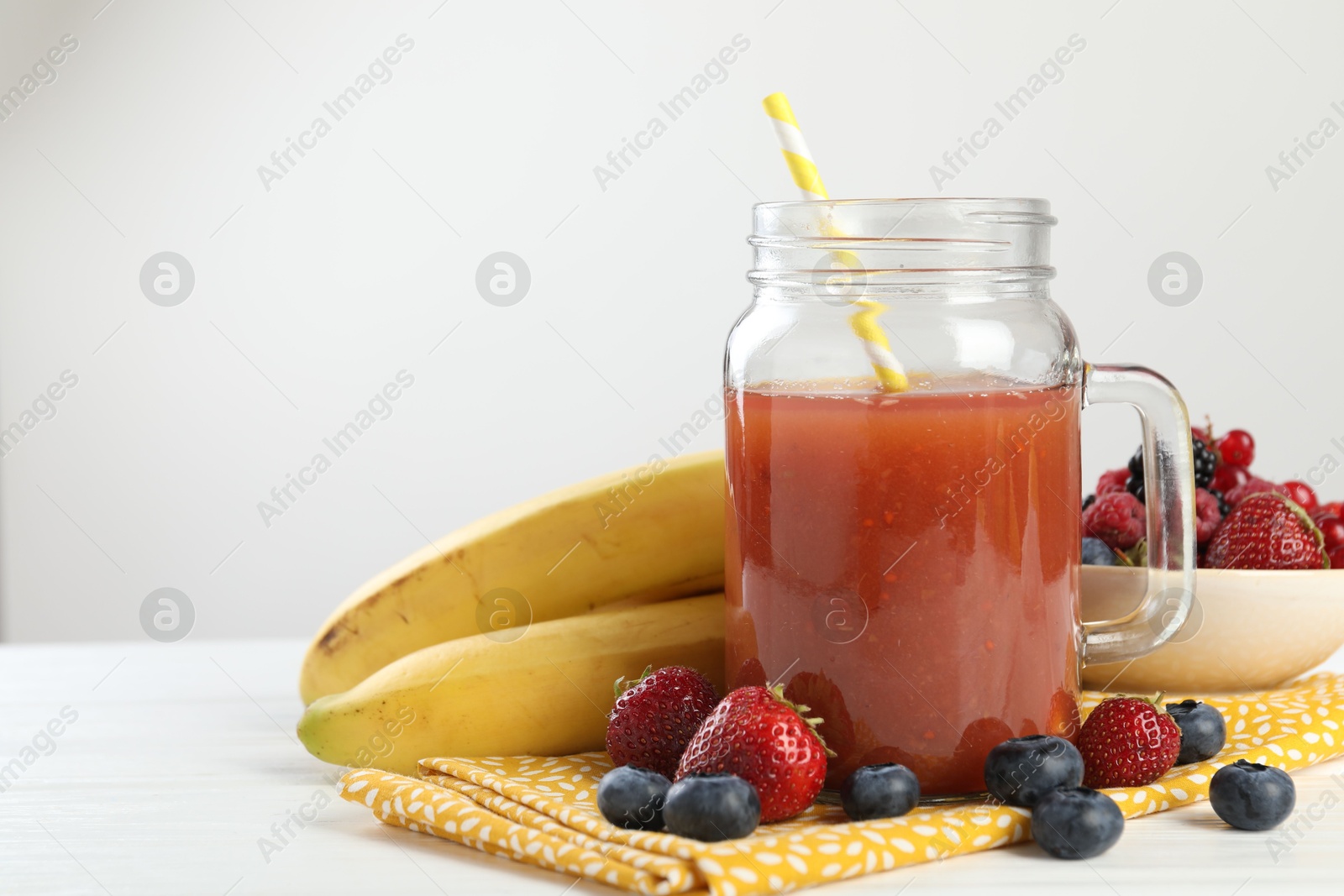 Superfood. Healthy drink in mason jar and ingredients on white wooden table against light grey background, closeup Photo of Superfood. Healthy drink in mason jar and ingredients on white wooden table against light grey background, closeup