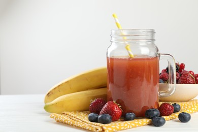 Photo of Superfood. Healthy drink in mason jar and ingredients on white wooden table against light grey background, closeup