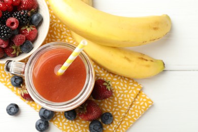 Photo of Superfood. Healthy drink in mason jar and ingredients on white wooden table, flat lay