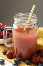 Photo of Superfood. Healthy drink in mason jar and ingredients on white wooden table against grey background, closeup