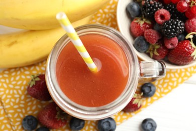 Photo of Superfood. Healthy drink in mason jar and ingredients on white table, flat lay