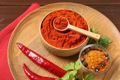 Photo of Different aromatic spices on wooden table, closeup