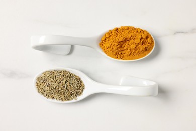 Photo of Aromatic spices on white marble table, flat lay