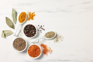 Photo of Different aromatic spices on white marble table, flat lay. Space for text