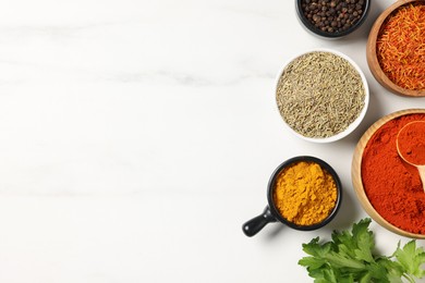 Photo of Different aromatic spices on white marble table, flat lay. Space for text