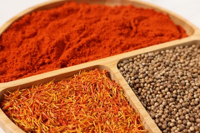 Photo of Different aromatic spices on table, closeup view