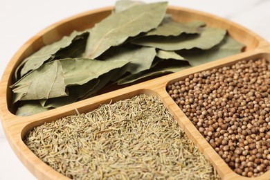 Photo of Different aromatic spices on white table, closeup
