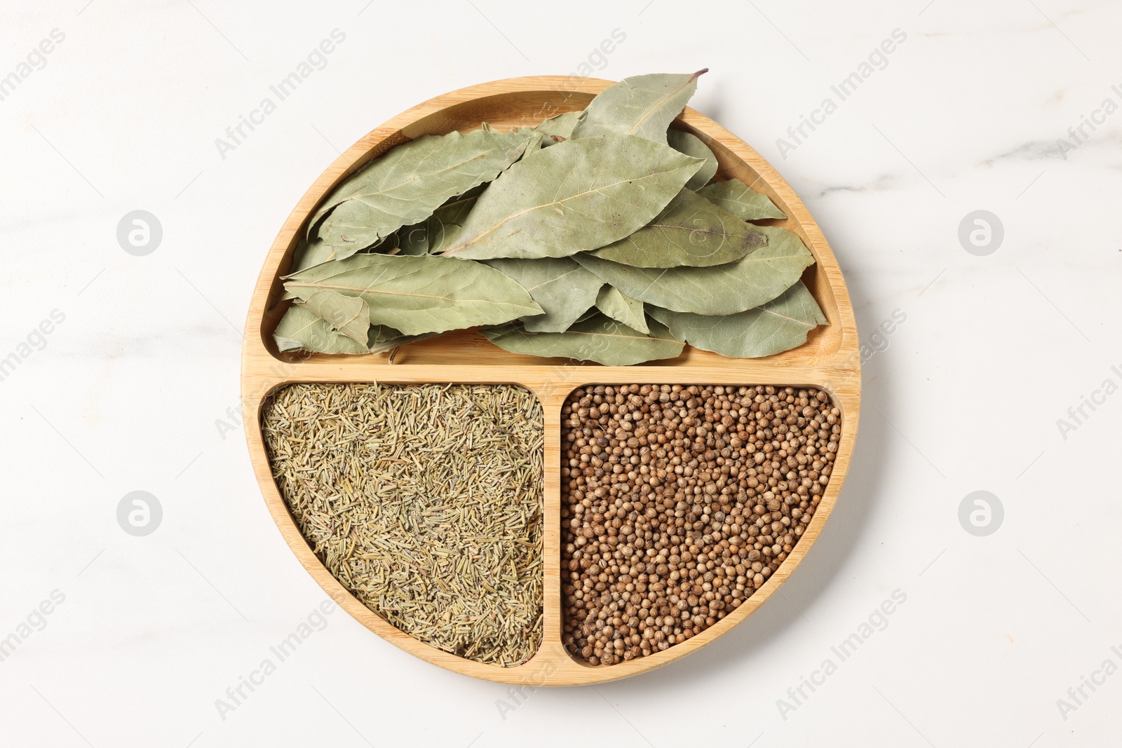 Photo of Different aromatic spices on white marble table, top view