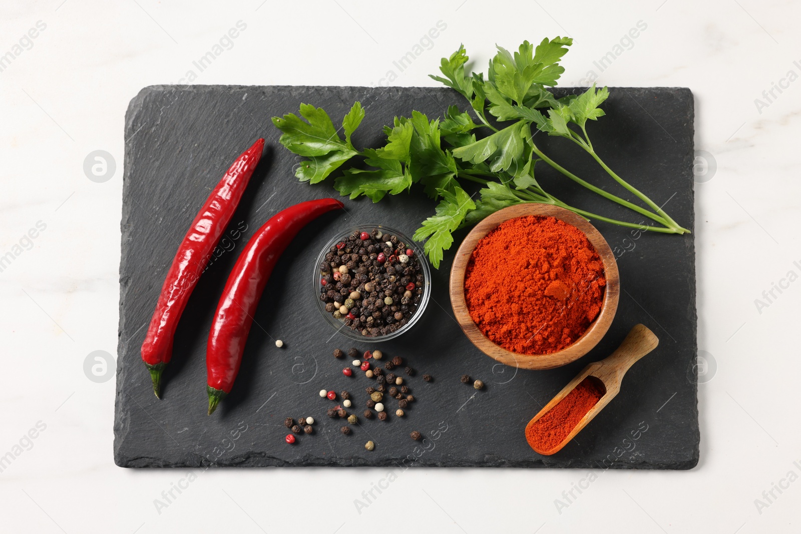 Photo of Different aromatic spices on white marble table, top view