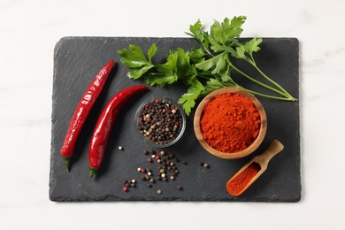 Photo of Different aromatic spices on white marble table, top view