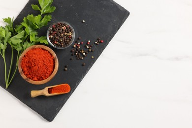 Photo of Different aromatic spices on white marble table, top view. Space for text