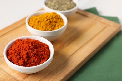 Photo of Different aromatic spices on white table, closeup