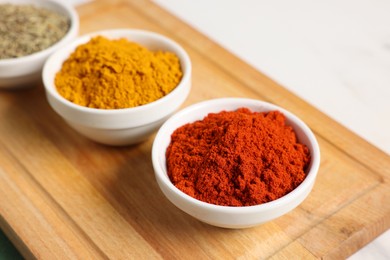 Photo of Different aromatic spices on white table, closeup
