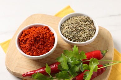 Photo of Different aromatic spices on white marble table, closeup