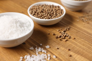 Photo of Different aromatic spices on wooden table, closeup