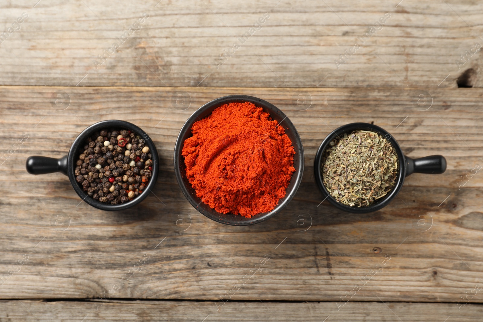 Photo of Different aromatic spices on wooden table, flat lay