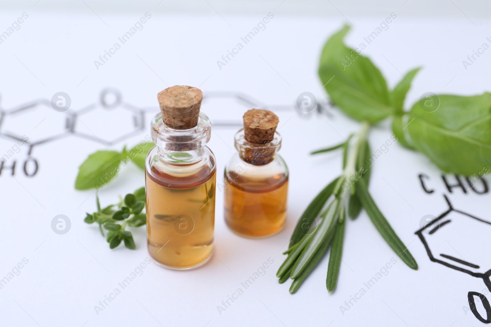 Different herbs and bottles of cosmetic products on paper with chemical formulas, closeup Photo of Different herbs and bottles of cosmetic products on paper with chemical formulas, closeup
