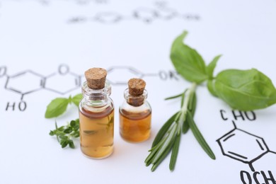 Photo of Different herbs and bottles of cosmetic products on paper with chemical formulas, closeup