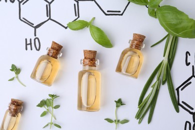 Photo of Different herbs and bottles of cosmetic products on paper with chemical formulas, flat lay