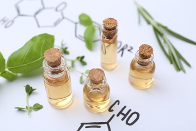 Photo of Different herbs and bottles of cosmetic products on paper with chemical formulas, closeup