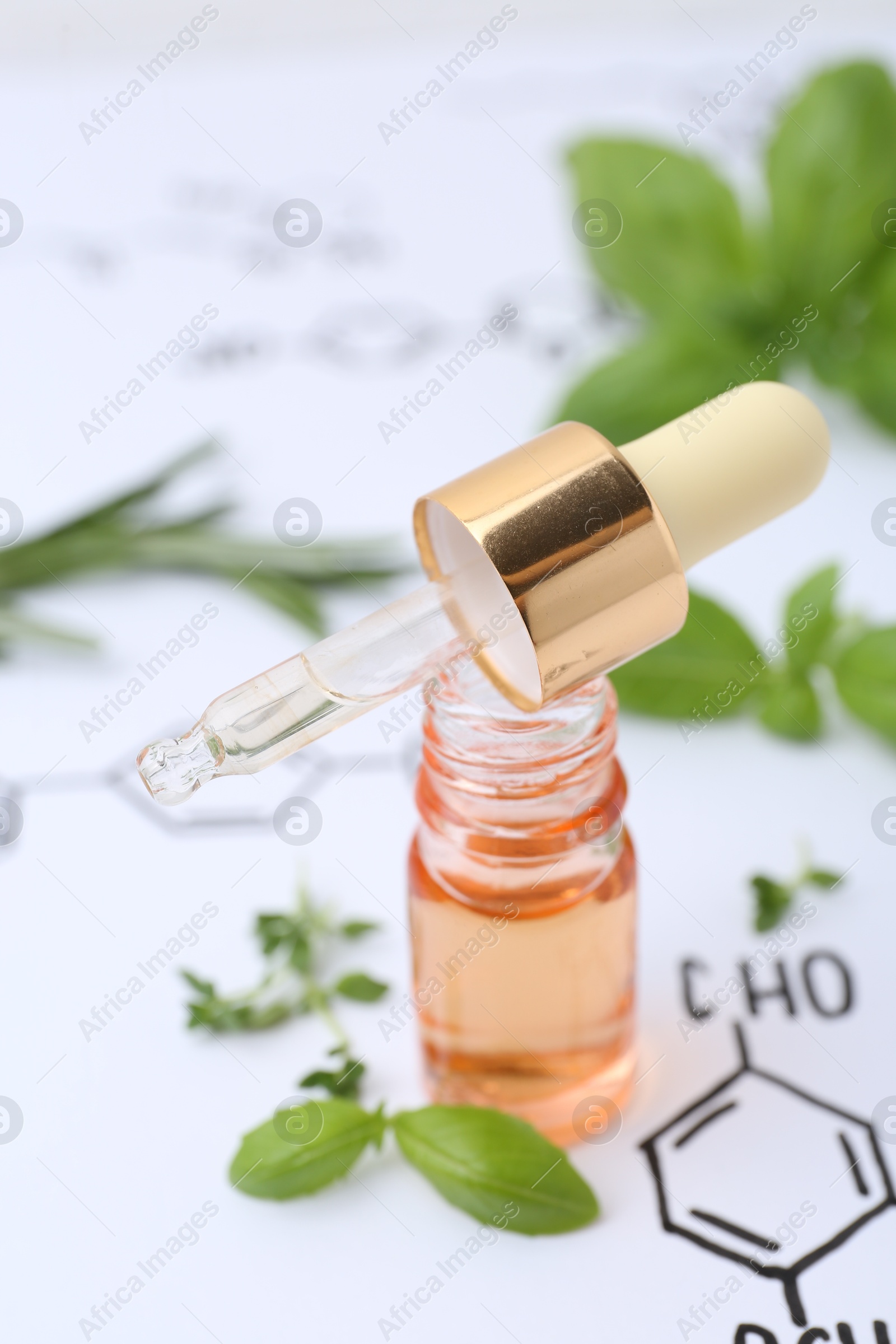 Photo of Different herbs and bottle of cosmetic product on paper with chemical formulas, closeup