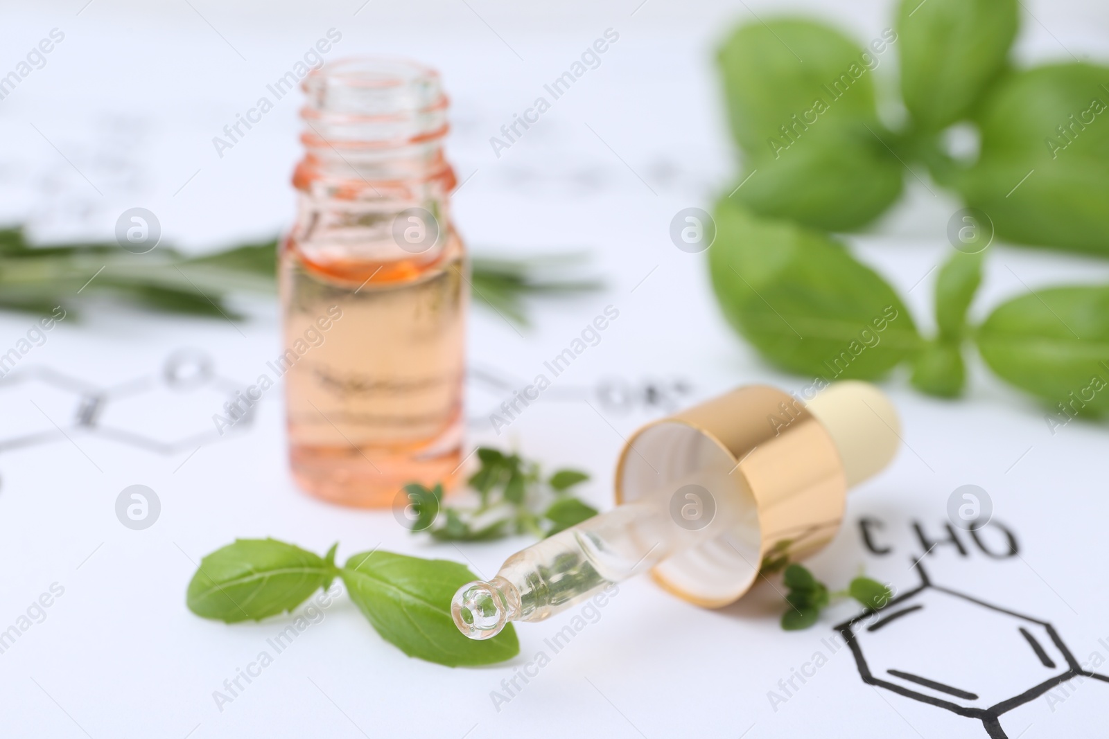 Different herbs and bottle of cosmetic product on paper with chemical formulas, closeup Photo of Different herbs and bottle of cosmetic product on paper with chemical formulas, closeup