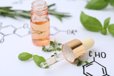 Photo of Different herbs and bottle of cosmetic product on paper with chemical formulas, closeup